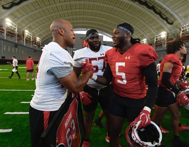 Gov. Wes Moore poses with Maryland defensive lineman Quashon Fuller at the team's practice. (Kenneth K. Lam/staff)